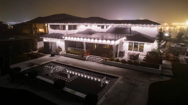 Roofline lighting following the curves of an arched stucco entry