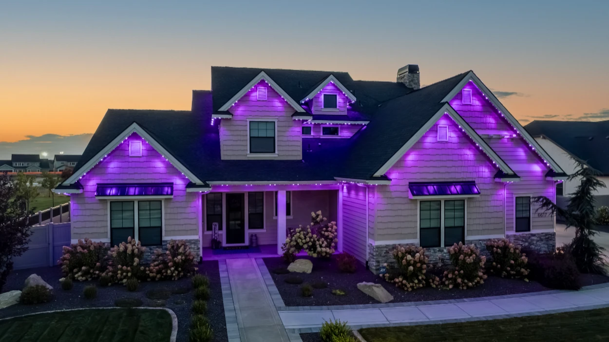 School-spirit blue and white lighting outlining a game-day home