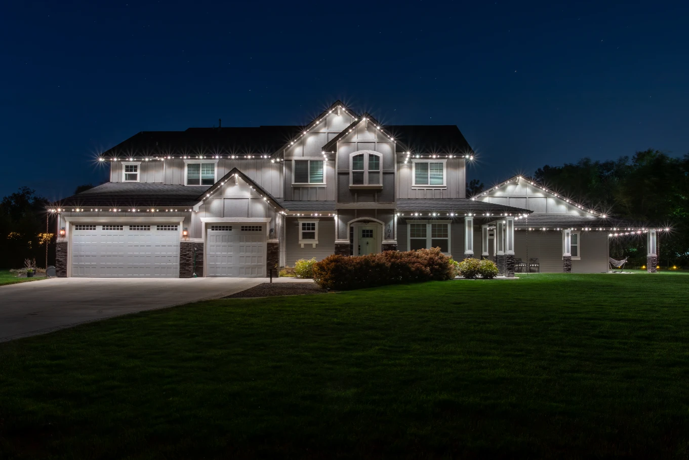 Understated white accent lighting on a mountain-style home with timber beams