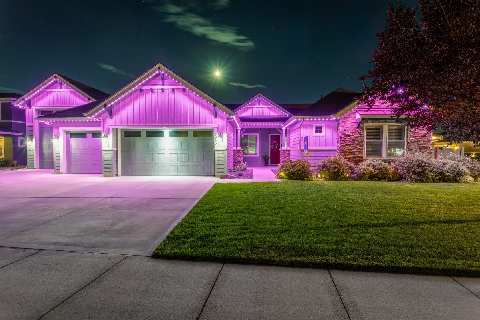 Colorful occasion lighting outlining every eave and peak of a large home