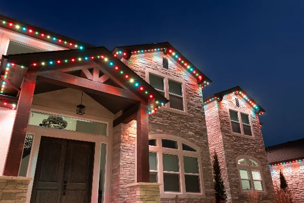 Red, white, and blue Fourth of July lighting outlining a suburban home