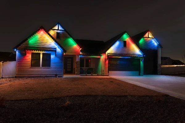 Patriotic lighting reflecting on a driveway during an evening celebration