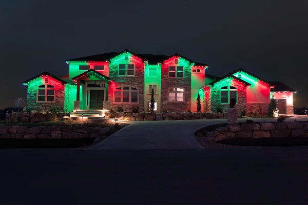 School-spirit blue and white lighting outlining a game-day home