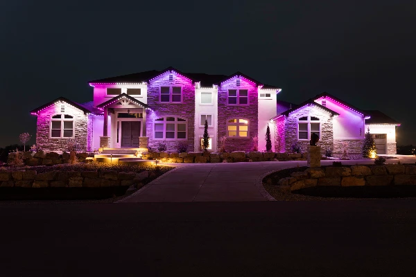 Festive multicolor chase pattern running along a home's roofline at night