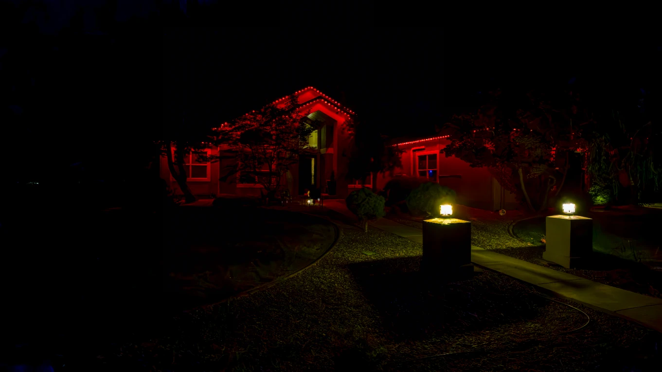 Festive multicolor chase pattern running along a home's roofline at night