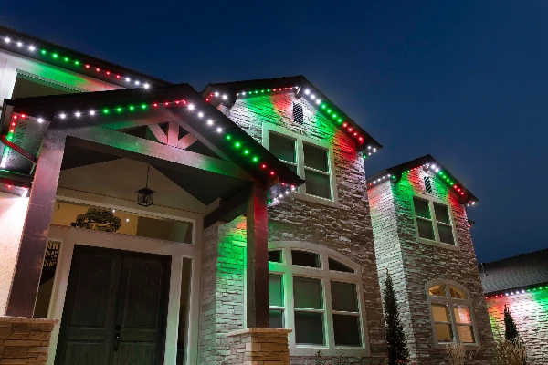 Pink and red Valentine's Day lighting along a front porch roofline