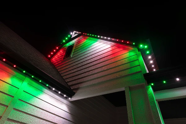 Green St. Patrick's Day lighting tracing the peaks of a brick home