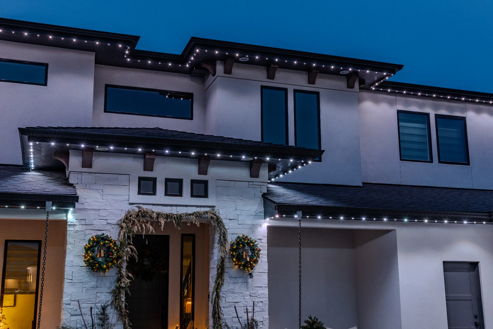 Understated white accent lighting on a mountain-style home with timber beams