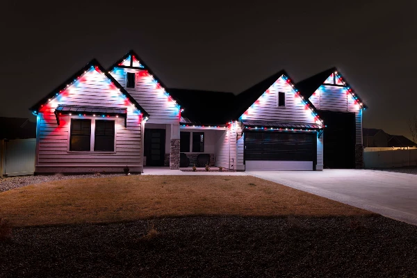 Colorful occasion lighting outlining every eave and peak of a large home